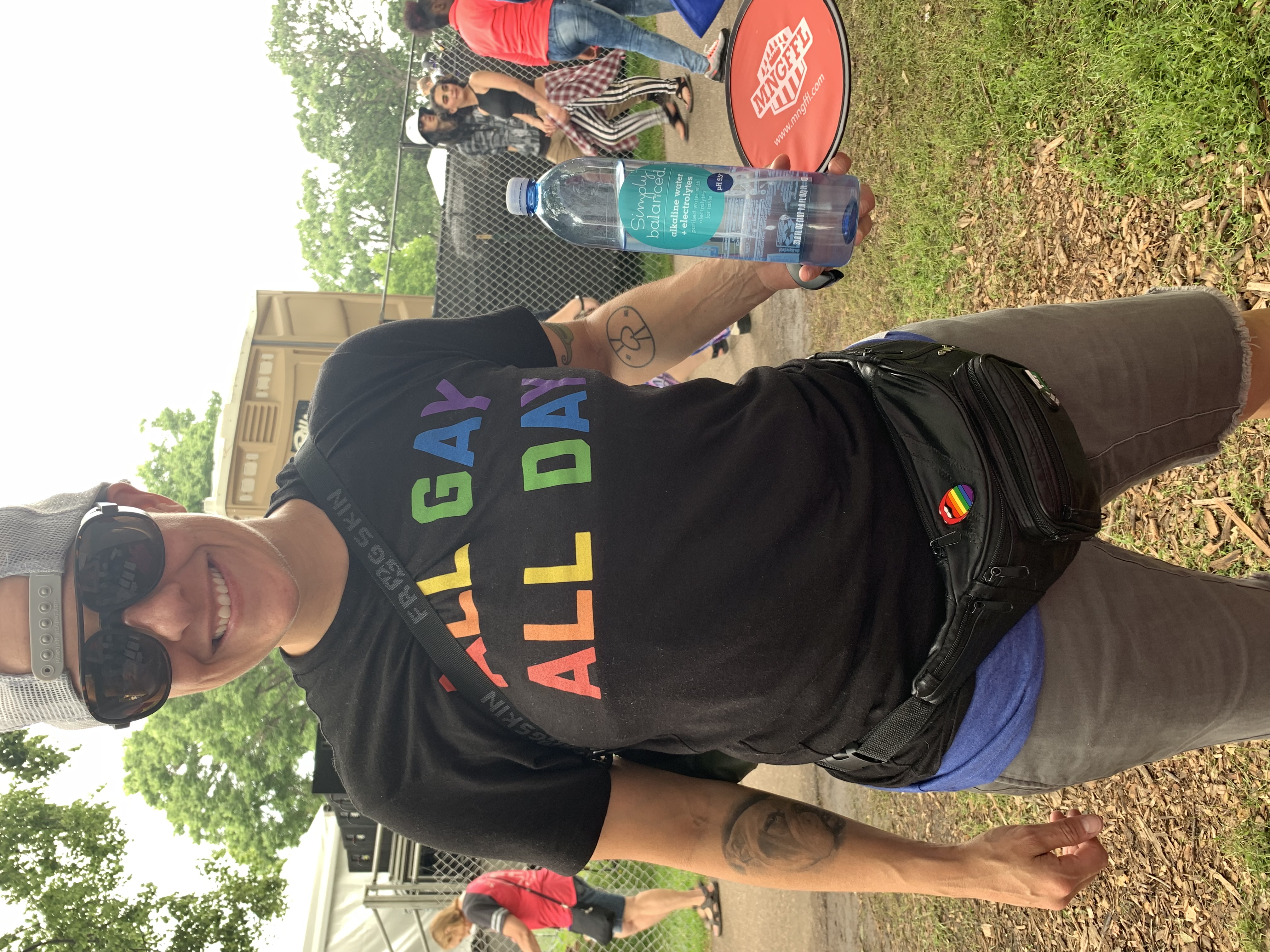Twin Cities Pride attendee sports their rainbow pride pin from Queen On The Scene vendor shop attending Twin Cities Pride