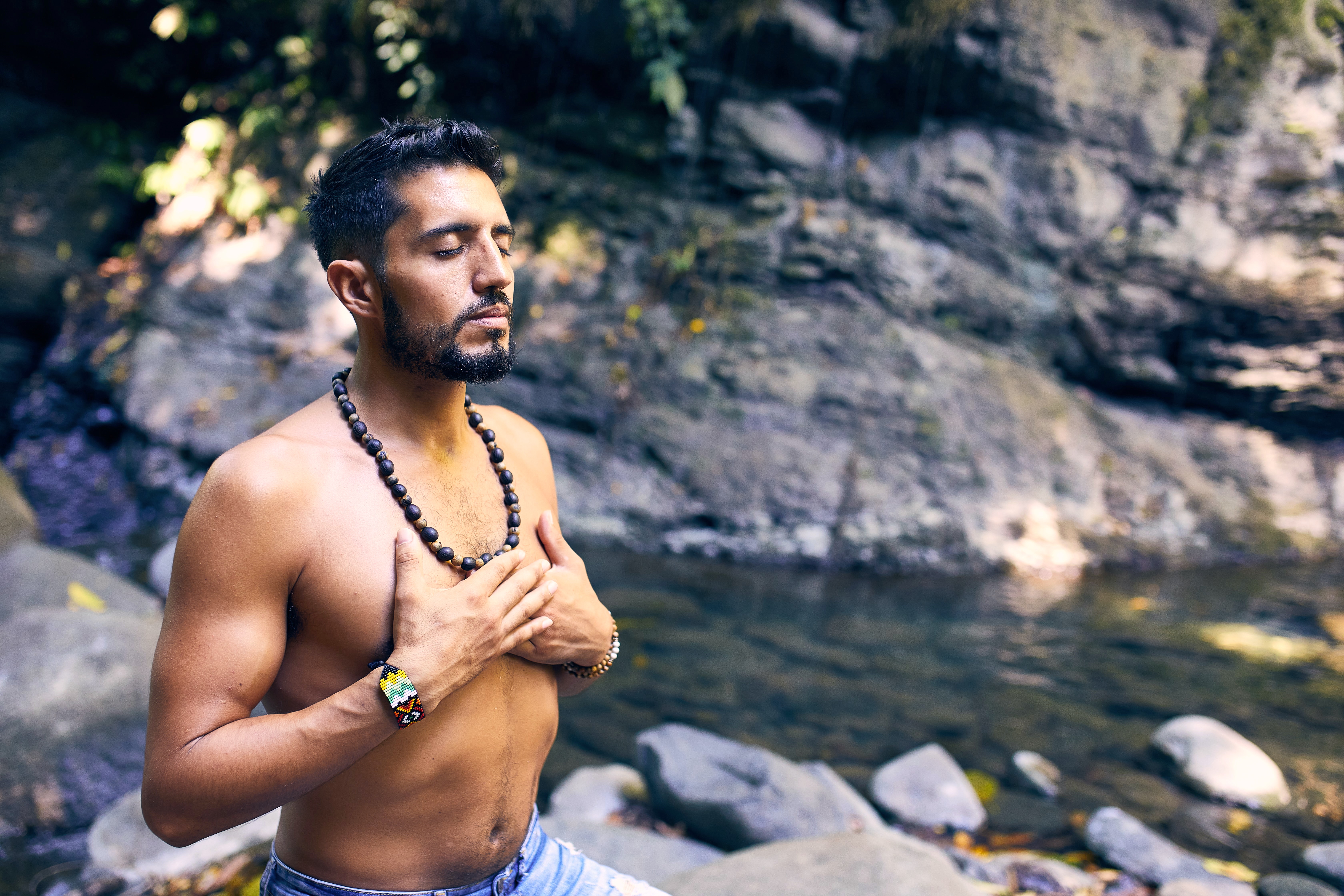 Man Meditating At Stream